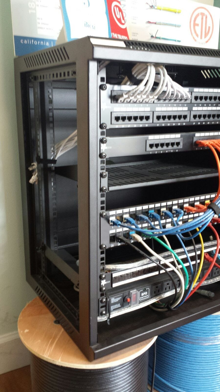 Wall cabinet build: Compact wall cabinet with patch panels, switch and surge-protected power.